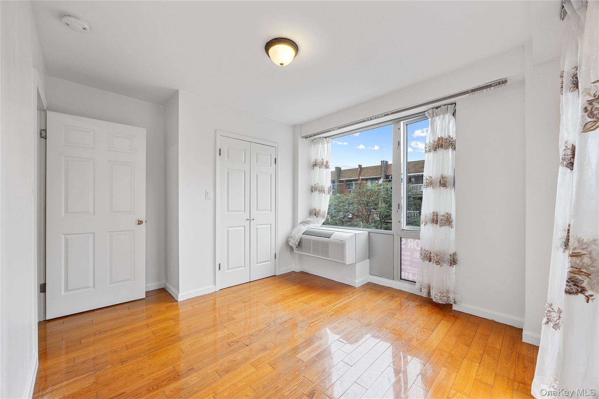 139-30 34th Avenue, Unit 3B Queens, NY 11354 - Photo 16 of 20 a view of an empty room with window