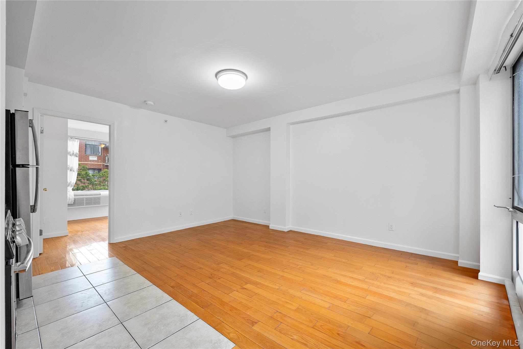 139-30 34th Avenue, Unit 3B Queens, NY 11354 - Photo 9 of 20 a view of an empty room with a window