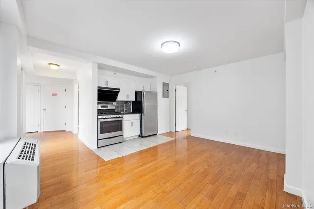 a view of kitchen with stainless steel appliances a refrigerator and a stove top oven