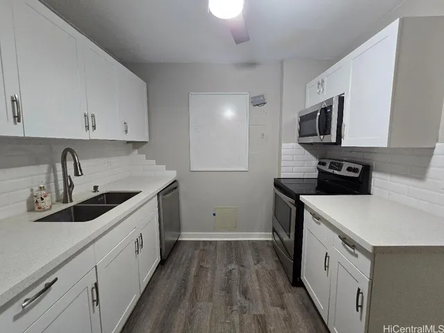 a kitchen with a sink stove and cabinets