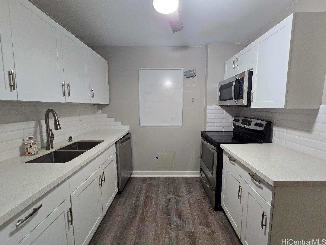 a kitchen with a sink stove and cabinets