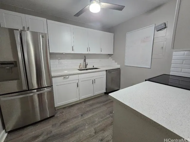 a kitchen with a refrigerator sink and cabinets
