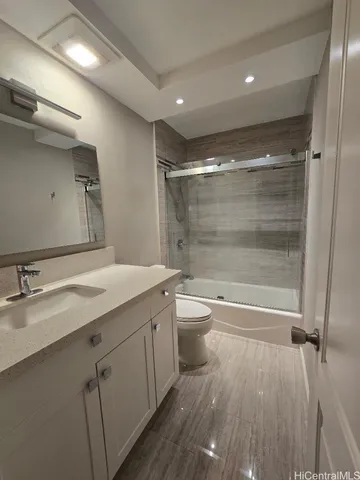 a bathroom with a double vanity sink toilet and shower