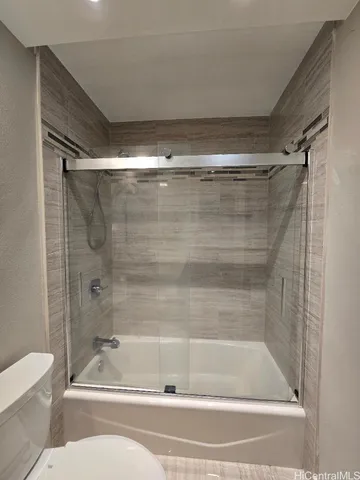 a bathroom with a shower and toilet