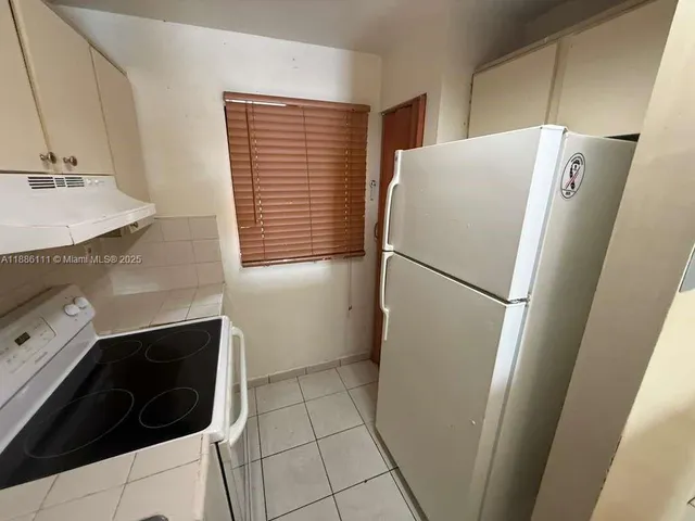 a refrigerator freezer sitting inside of a kitchen