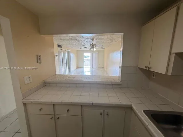 a kitchen with a sink and cabinets