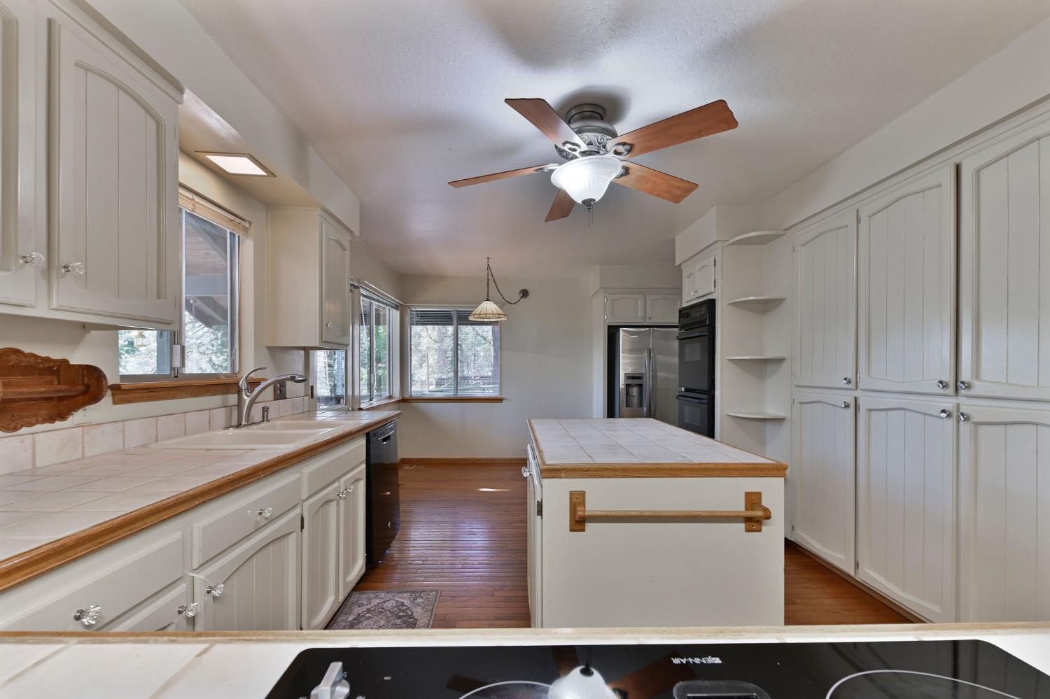 2637 Ruth Lane Arnold, CA 95223 - Photo 13 of 91 a kitchen with kitchen island a counter top space appliances and cabinets