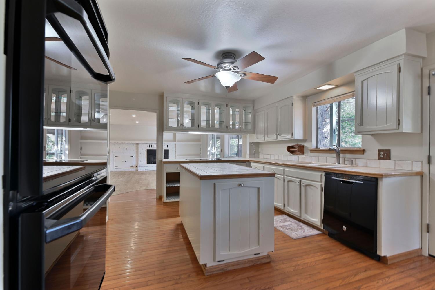 2637 Ruth Lane Arnold, CA 95223 - Photo 15 of 91 a kitchen with stainless steel appliances kitchen island granite countertop a stove a sink and a refrigerator