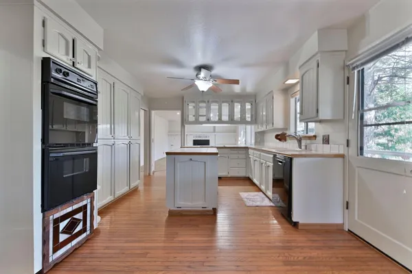 a spacious bathroom with a double vanity sink mirror and window