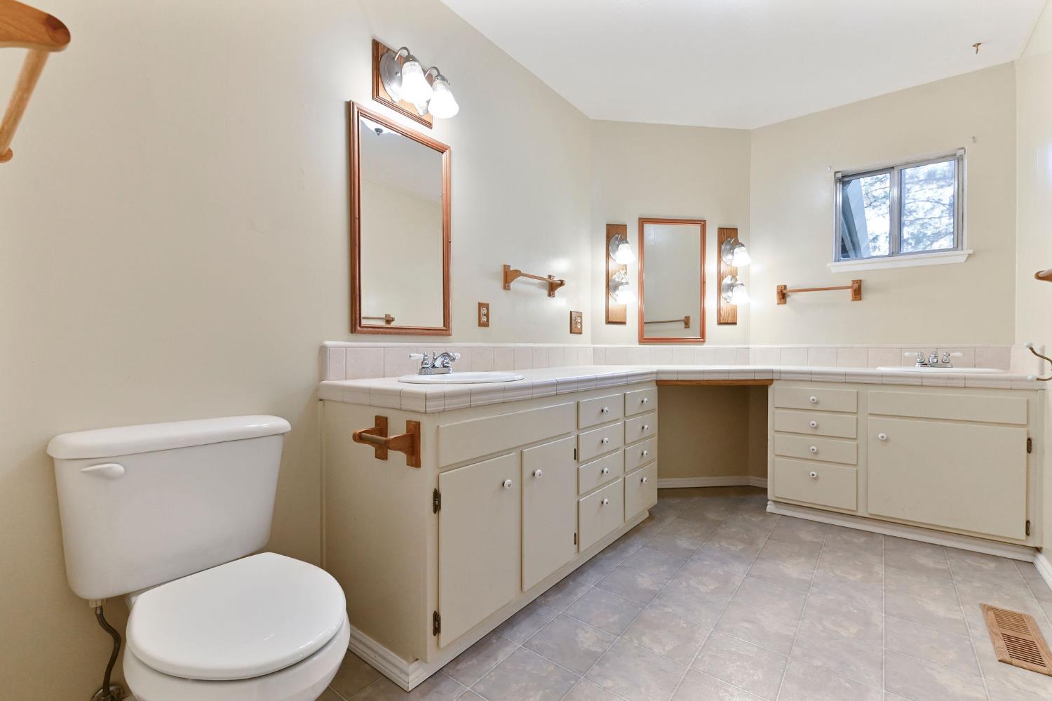 2637 Ruth Lane Arnold, CA 95223 - Photo 26 of 91 a bathroom with a granite countertop toilet sink and mirror