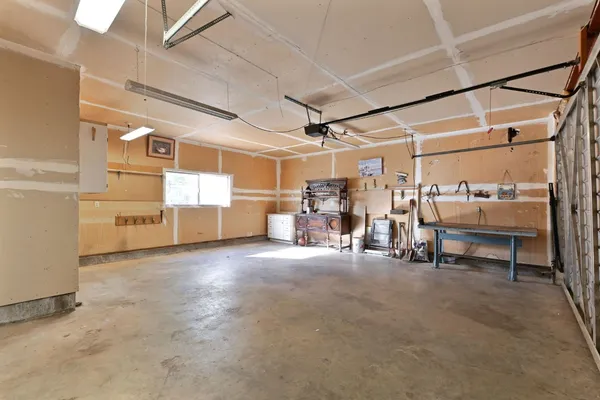 a spacious bathroom with a double vanity sink a mirror and a toilet