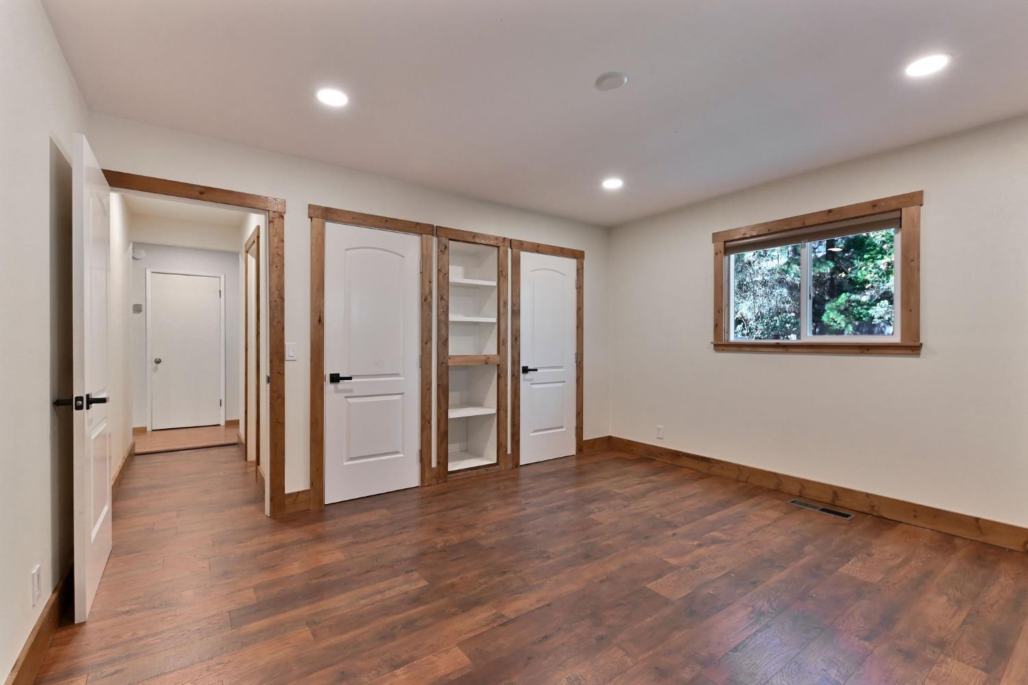 2637 Ruth Lane Arnold, CA 95223 - Photo 39 of 91 a view of an empty room with wooden floor and window