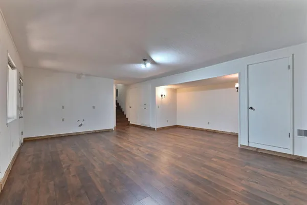 a view of a wooden balcony and trees