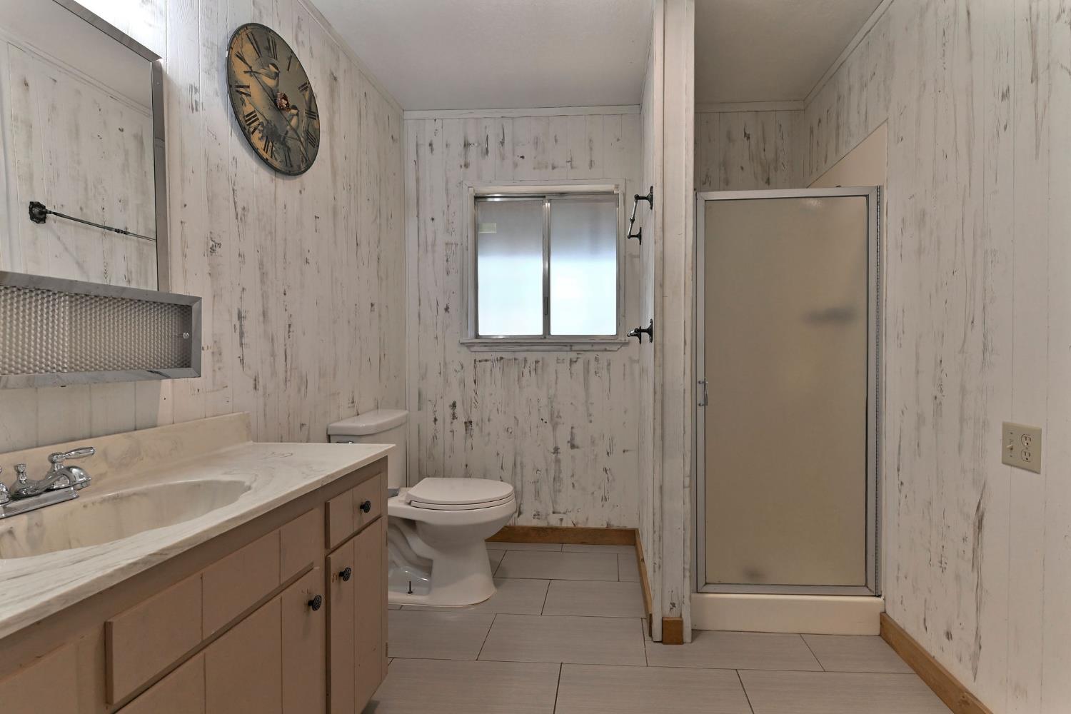 2637 Ruth Lane Arnold, CA 95223 - Photo 44 of 91 a bathroom with a toilet a sink a vanity and mirror