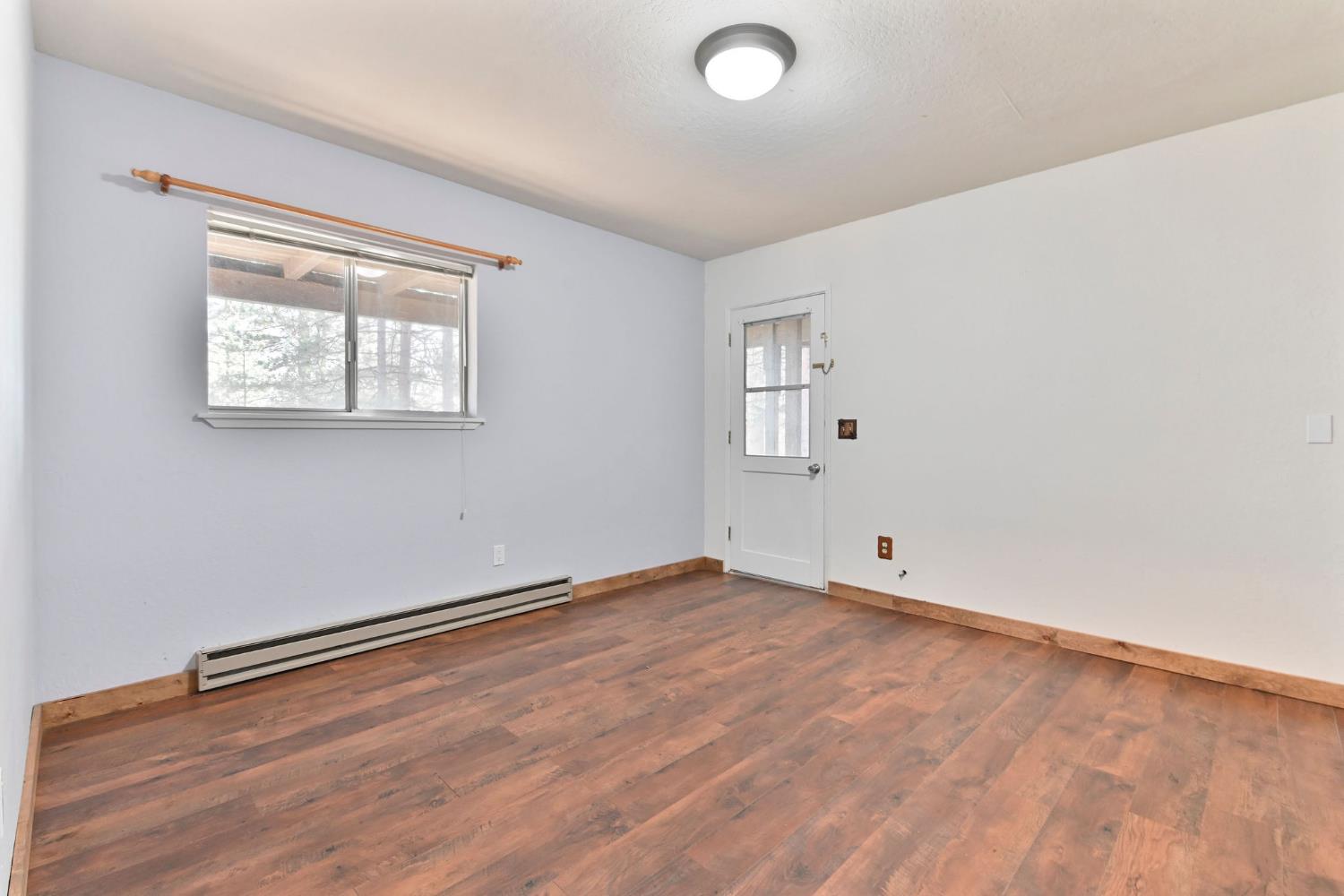 2637 Ruth Lane Arnold, CA 95223 - Photo 47 of 91 an empty room with wooden floor and windows