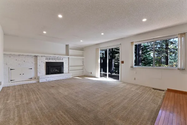a view of an empty room with a kitchen