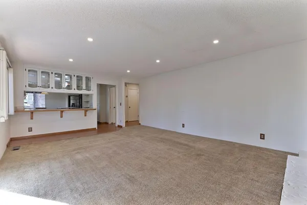 a kitchen with granite countertop a sink appliances cabinets and a counter top space