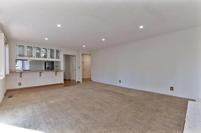 a kitchen with granite countertop a sink appliances cabinets and a counter top space