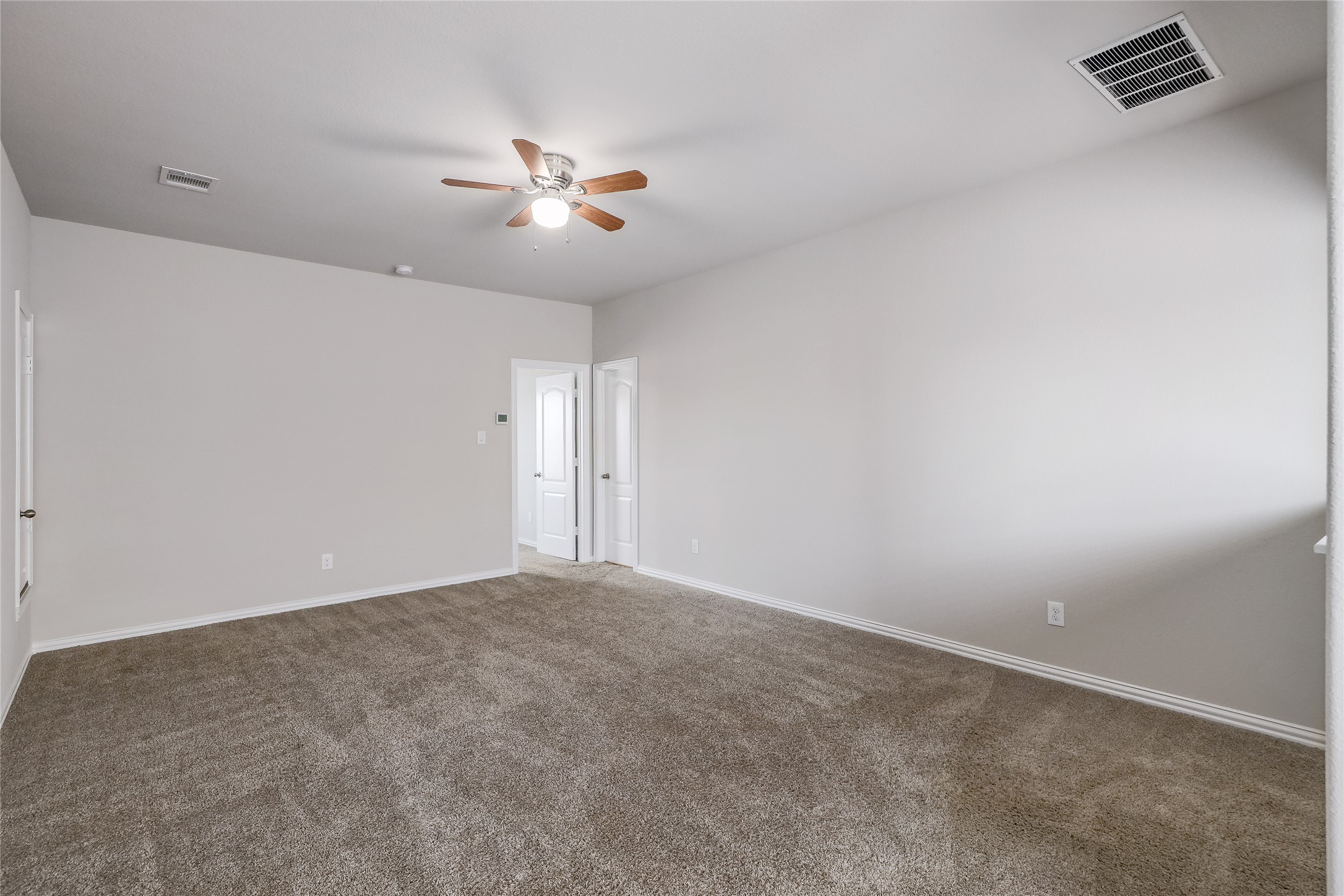 205 Penna Lane Georgetown, TX 78628 - Photo 23 of 32 A spacious room offers comfortable carpeting, ready for personalization.
