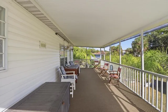 a view of a house with a balcony and tree s