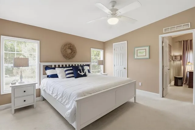 a bedroom with a large bed and a window