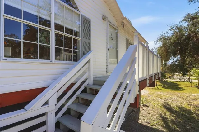 a living room with furniture and potted plant