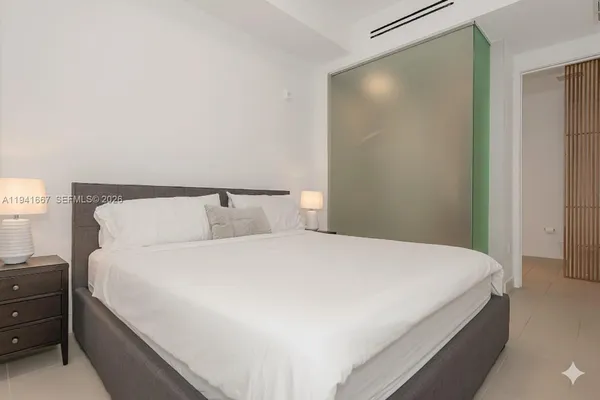 a bedroom with a bed and a night stand