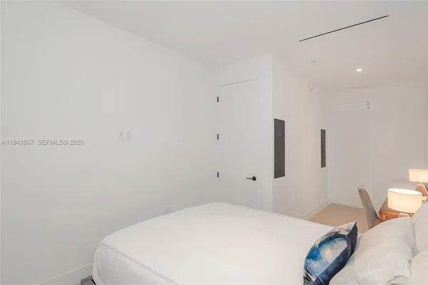 a bedroom with a bed and a table
