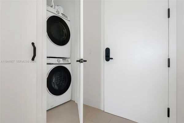 a view of a hallway with washer and dryer