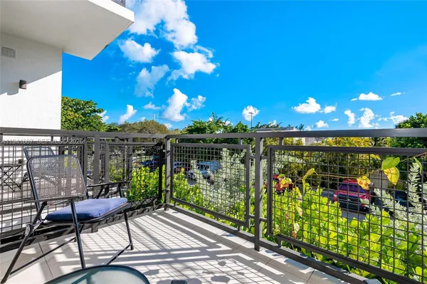 a view of a chairs and table in patio