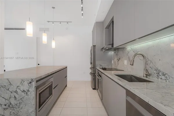 a kitchen with stainless steel appliances granite countertop a sink and a stove