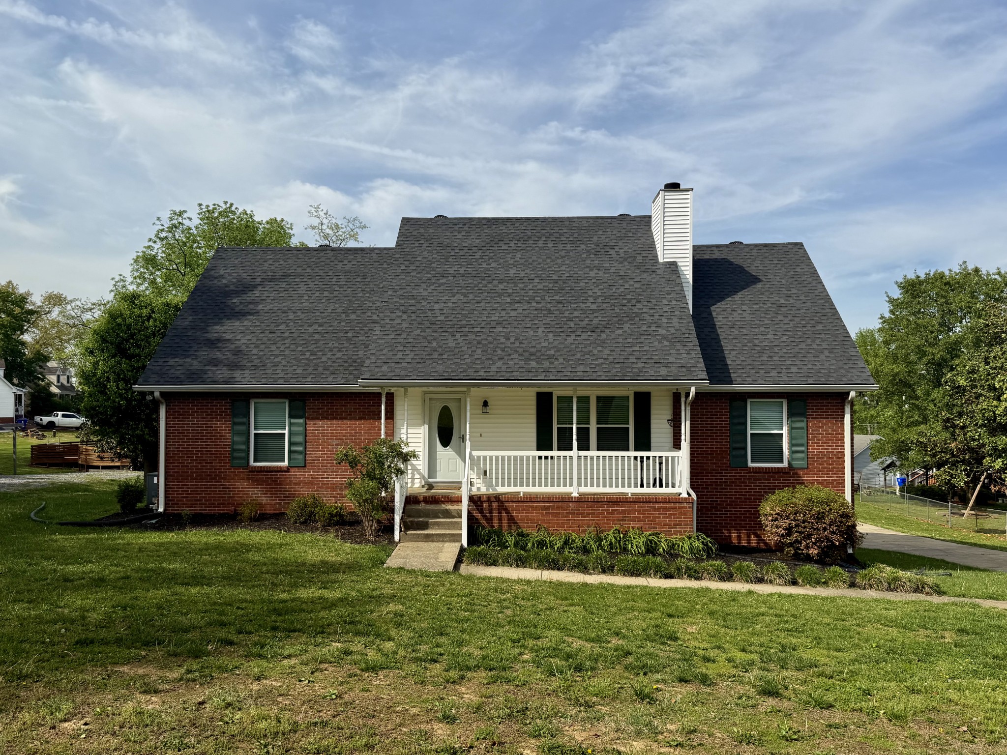 a front view of a house with a garden