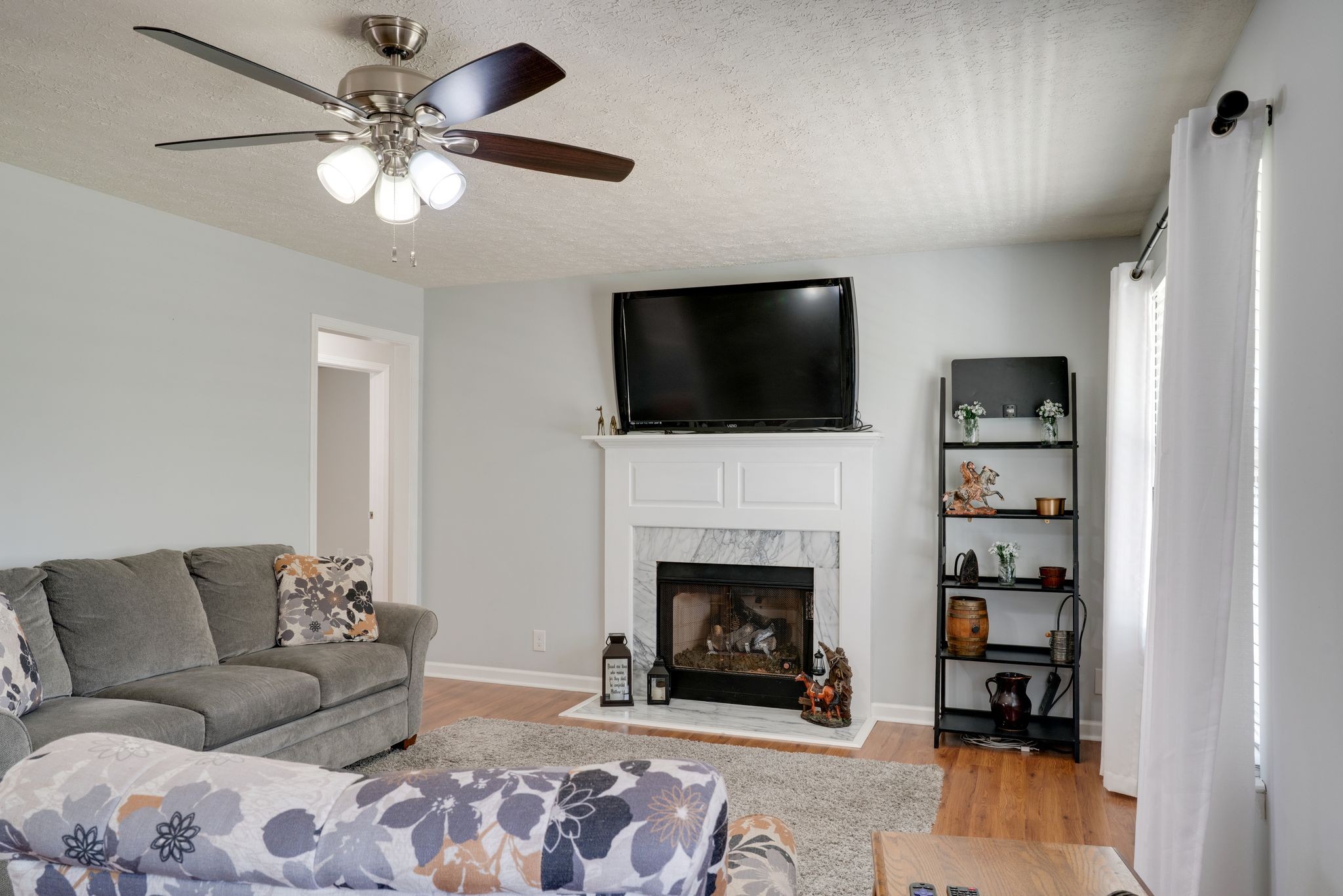 145 South Palmers Chapel Road White House, TN 37188 - Photo 4 of 30 a living room with furniture a flat screen tv and a fireplace