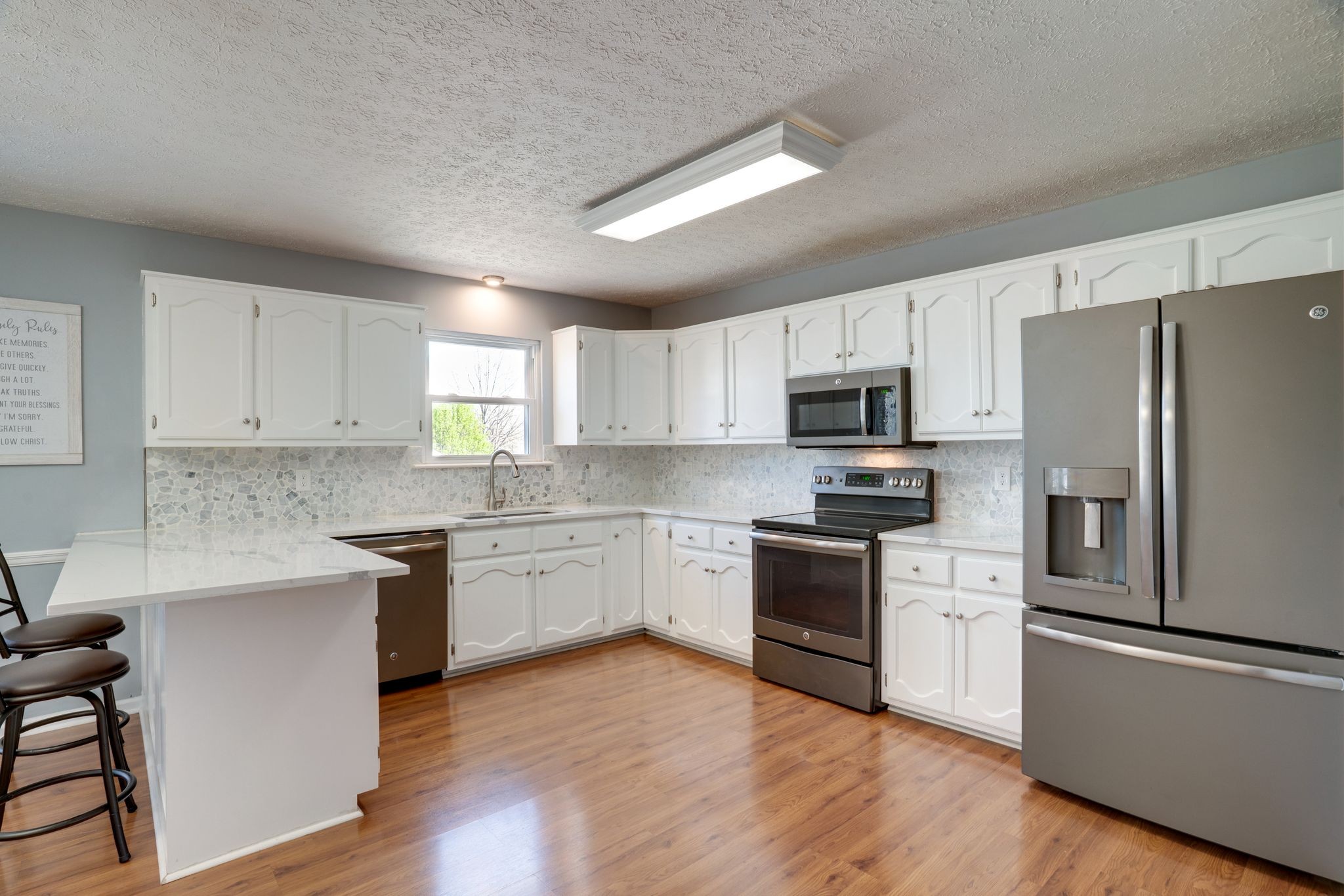 145 South Palmers Chapel Road White House, TN 37188 - Photo 6 of 30 a kitchen with granite countertop white cabinets and stainless steel appliances