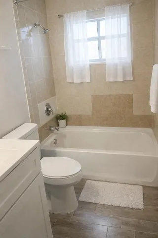 a bathroom with a sink a window and a toilet