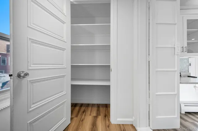 a view of walk in closet with empty racks