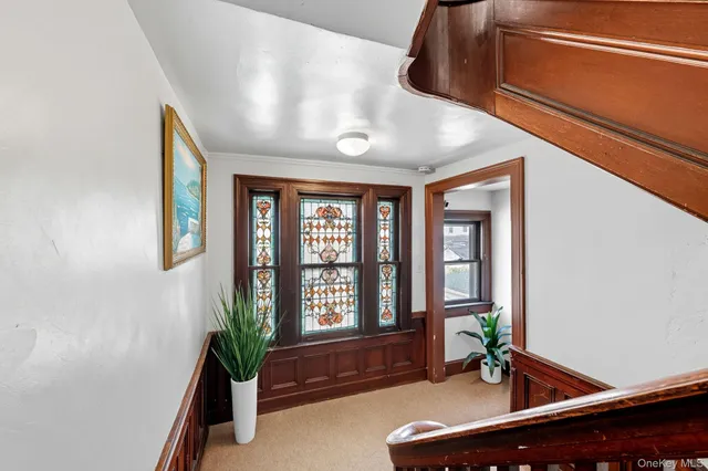 a living room with furniture potted plant and windows