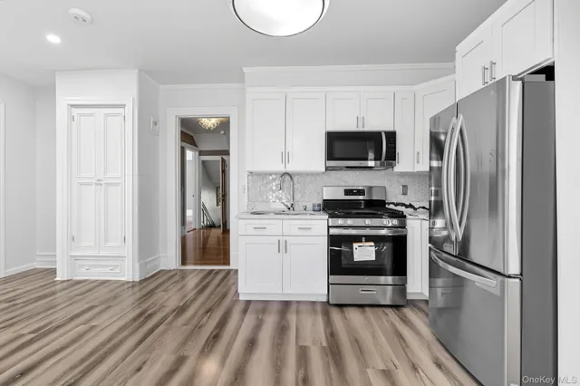 a kitchen with a refrigerator stove and microwave