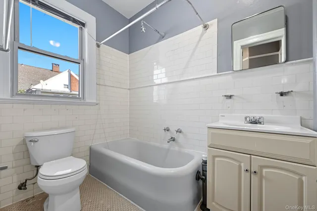 a bathroom with a sink a toilet and mirror