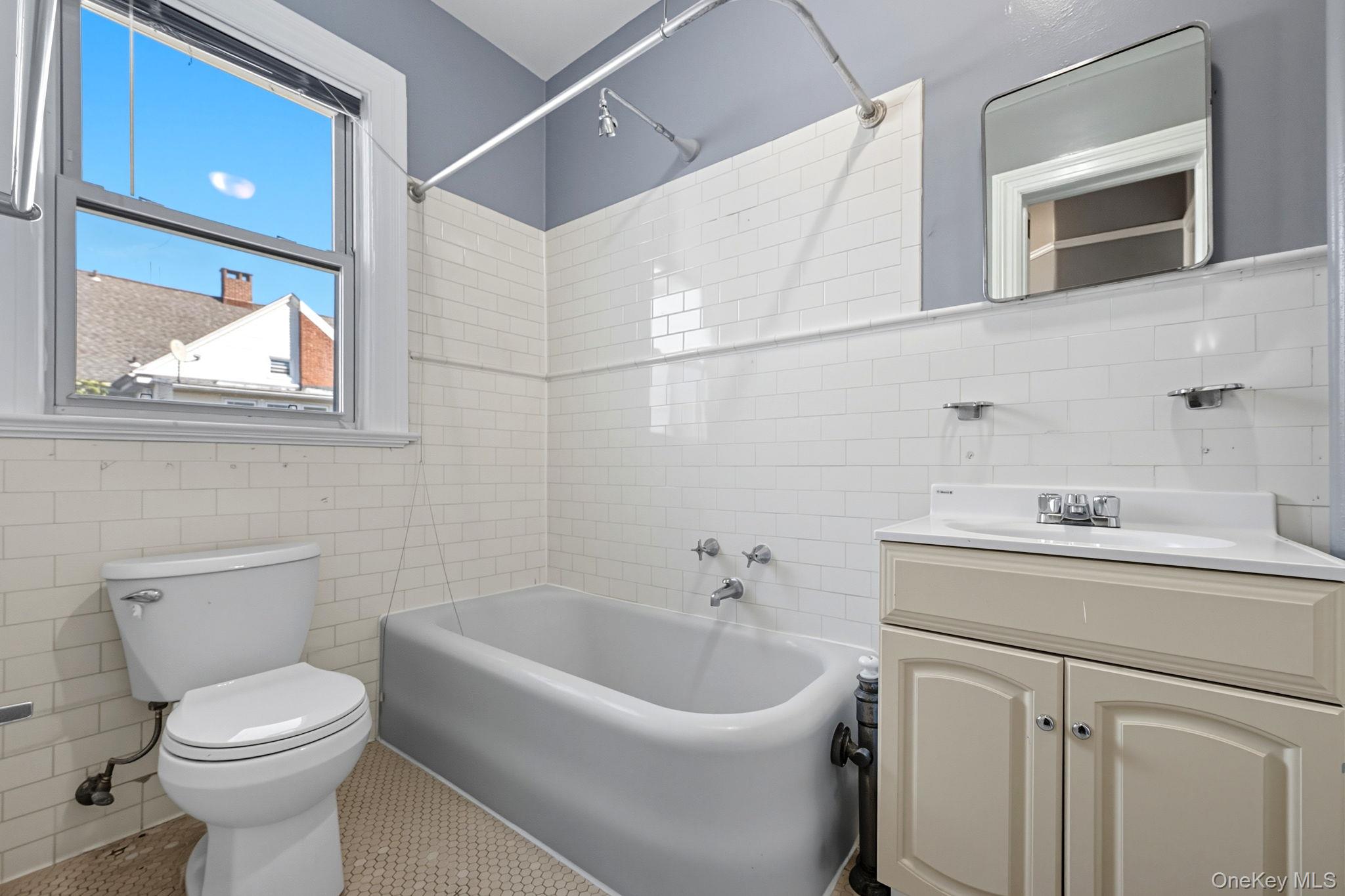 165 Park Avenue, Unit 2 Mount Vernon, NY 10550 - Photo 10 of 20 a bathroom with a sink a toilet and mirror