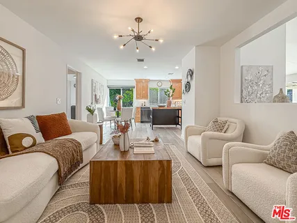 a living room with furniture and a chandelier