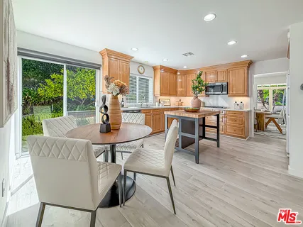 a dining room with furniture window and wooden floor