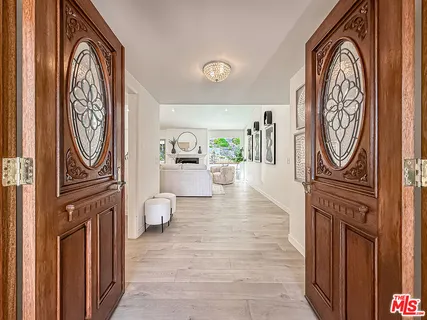 a hallway with painting on the wall and a window