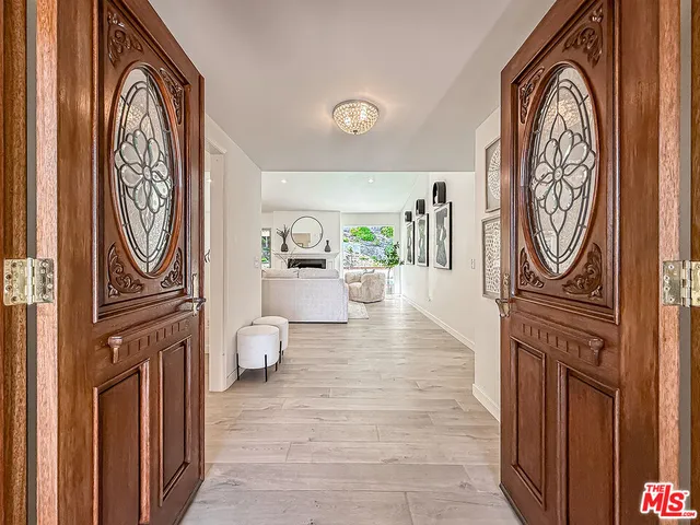 a hallway with painting on the wall and a window