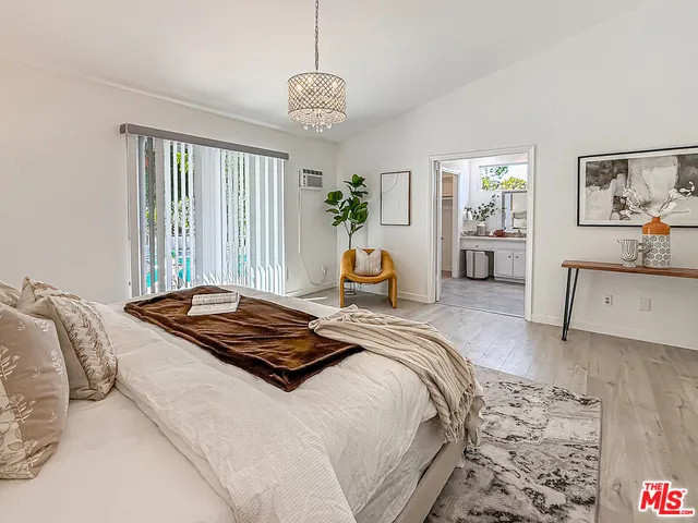 a bedroom with bed and window