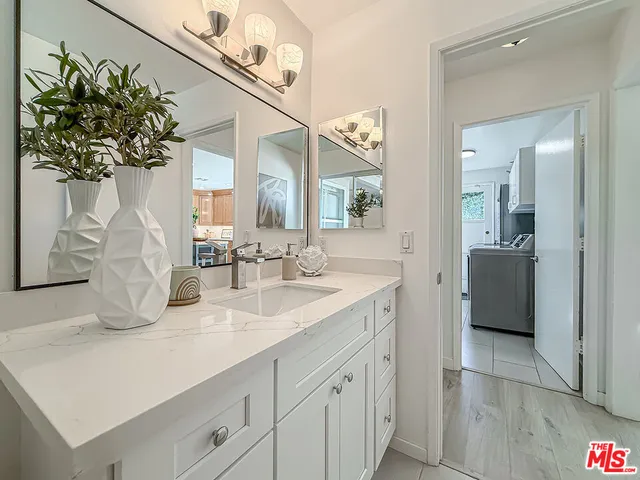 a spacious bathroom with a double vanity sink and a mirror