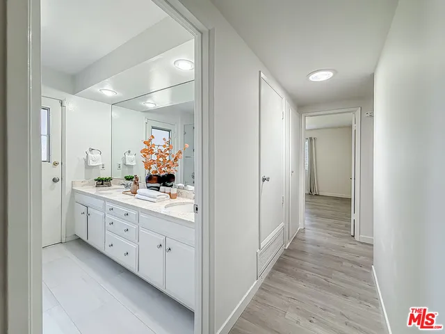 a bathroom with a double vanity sink and mirror