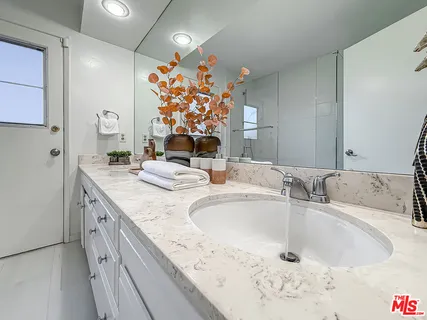 a bathroom with a double vanity sink mirror and double