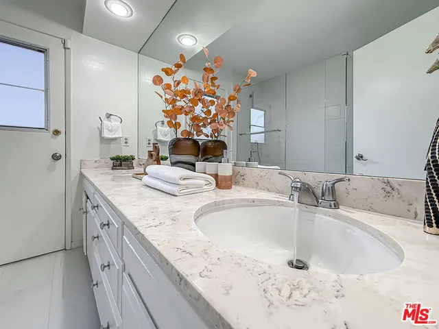 a bathroom with a double vanity sink mirror and double