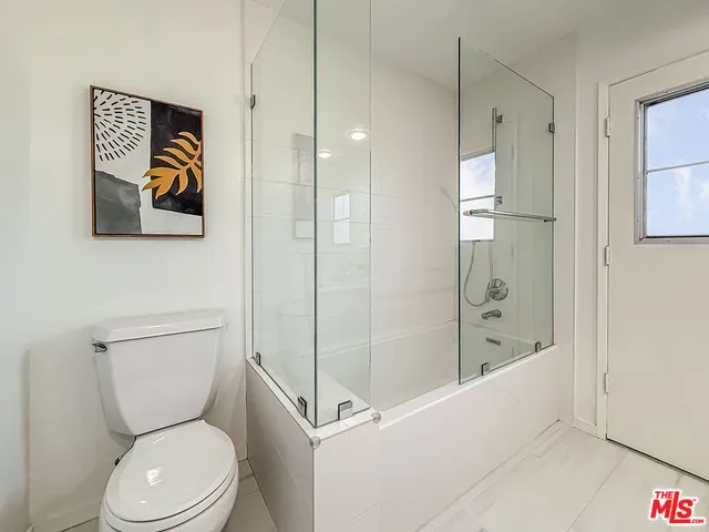 a bathroom with a toilet and a shower